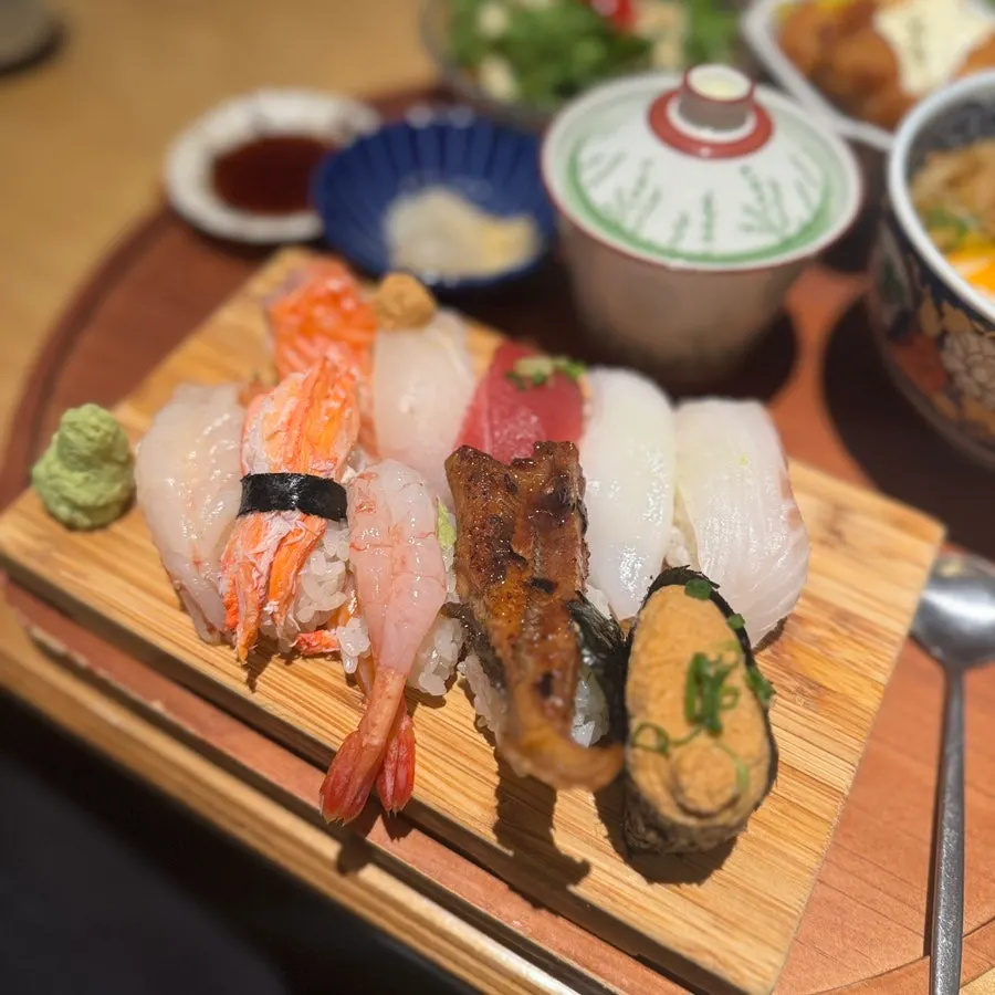 A plate holding many kinds of sushi