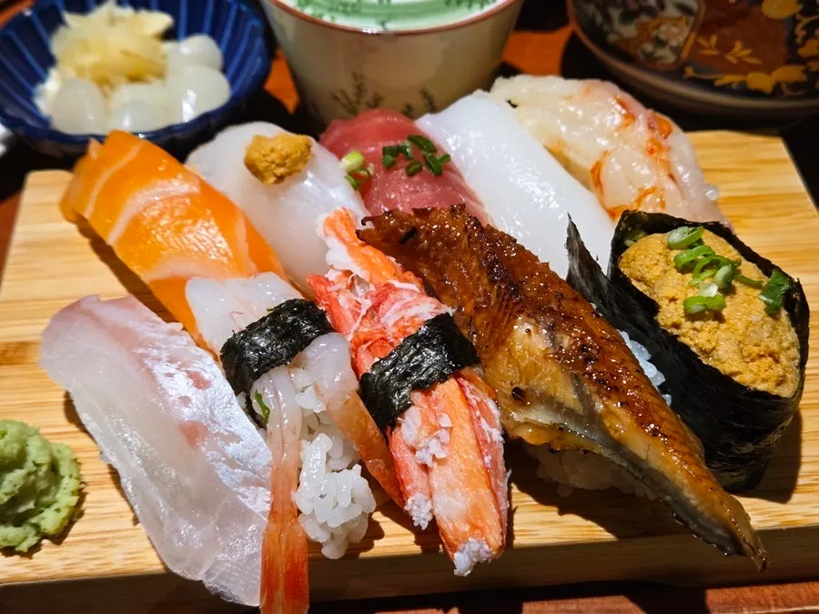 Colorful sushi pieces neatly arranged on one plate