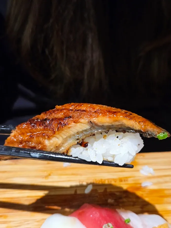 Picking up a piece of salmon sushi