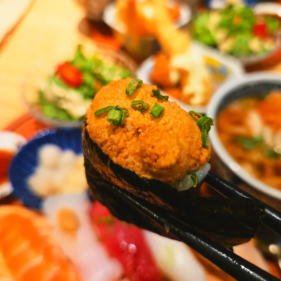 Salmon sushi topped with a long slice of salmon