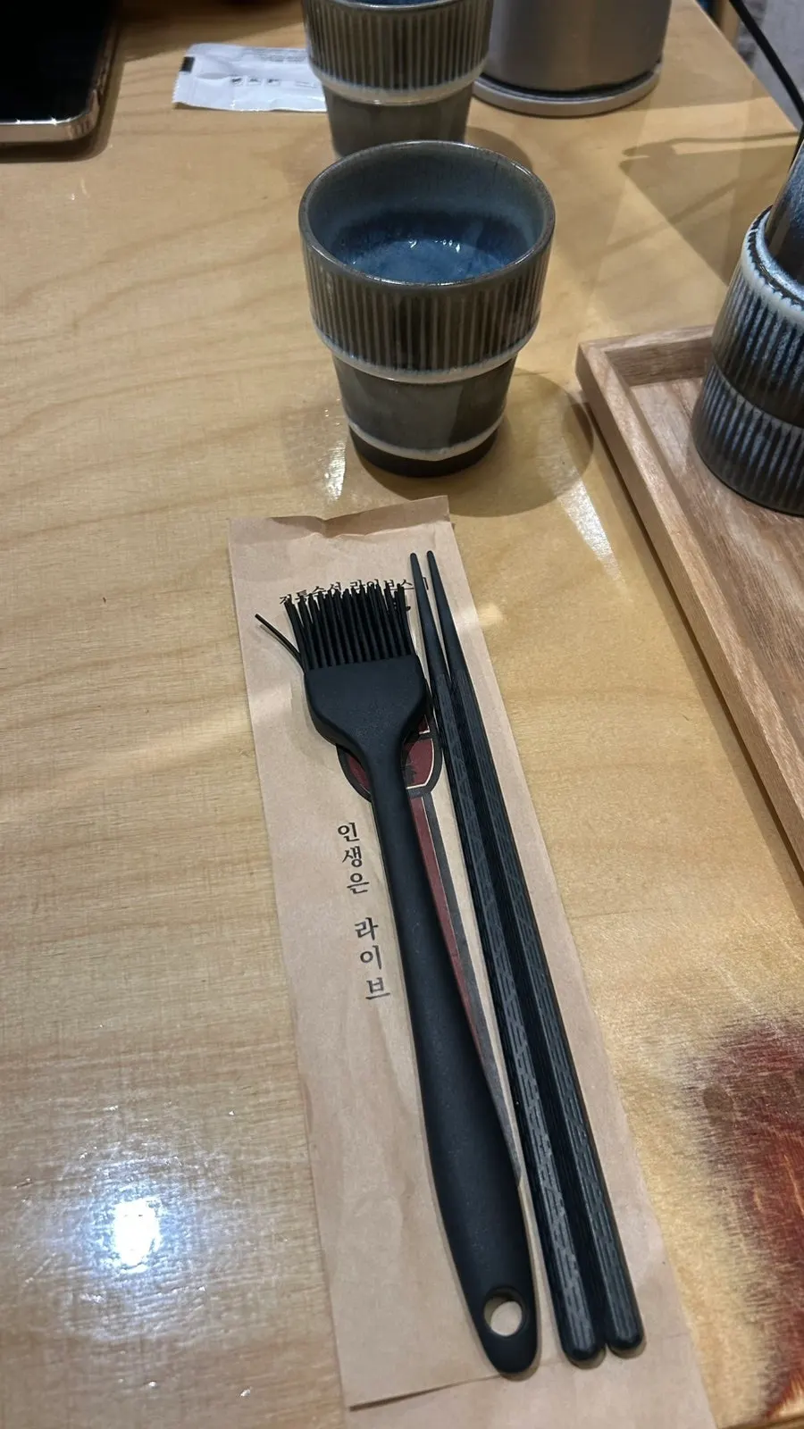 Table setting with soy sauce brush at Sushi Doku The Songdo