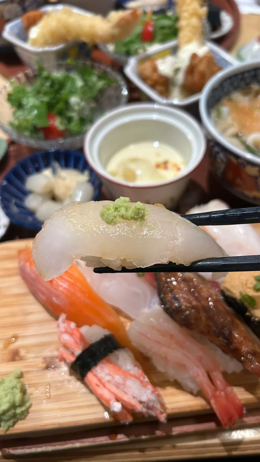 10 pieces of sushi brushed with soy sauce