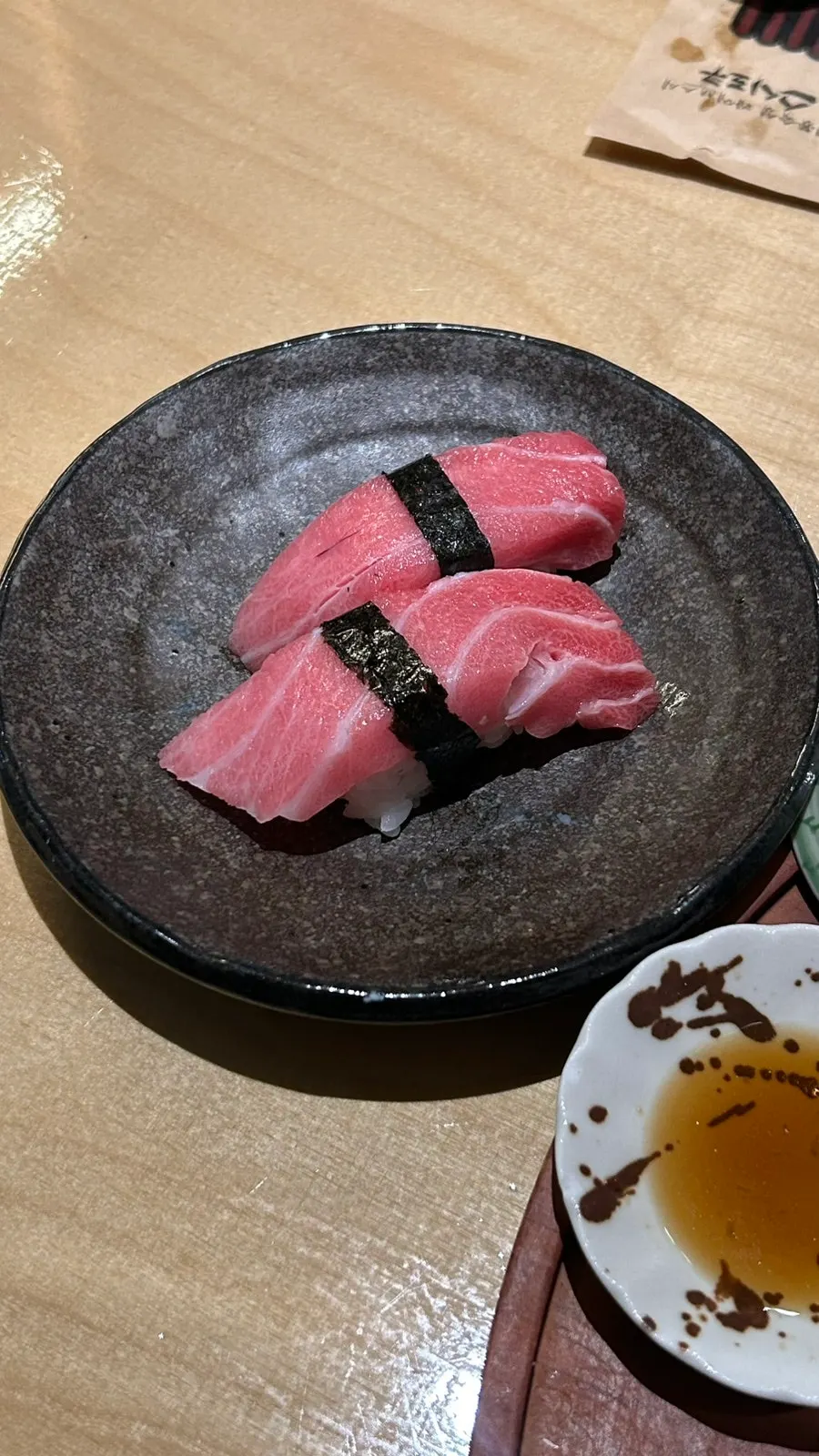 A plate of aged sushi with varied cuts