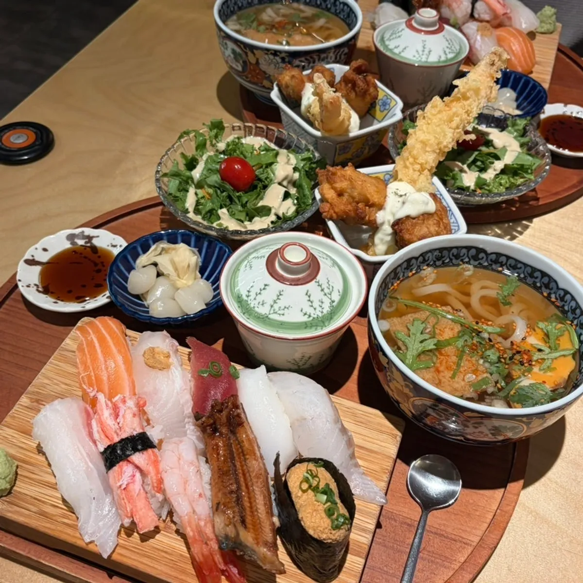 Premium sushi set with 10 pieces of sushi, udon, and fried food all on one tray