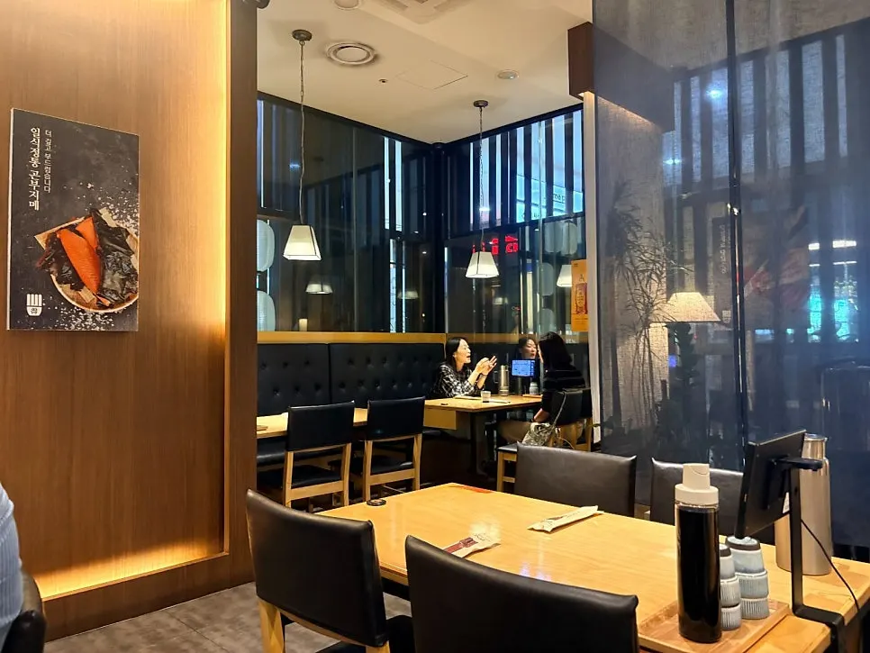 Softly lit restaurant interior with booth-style tables