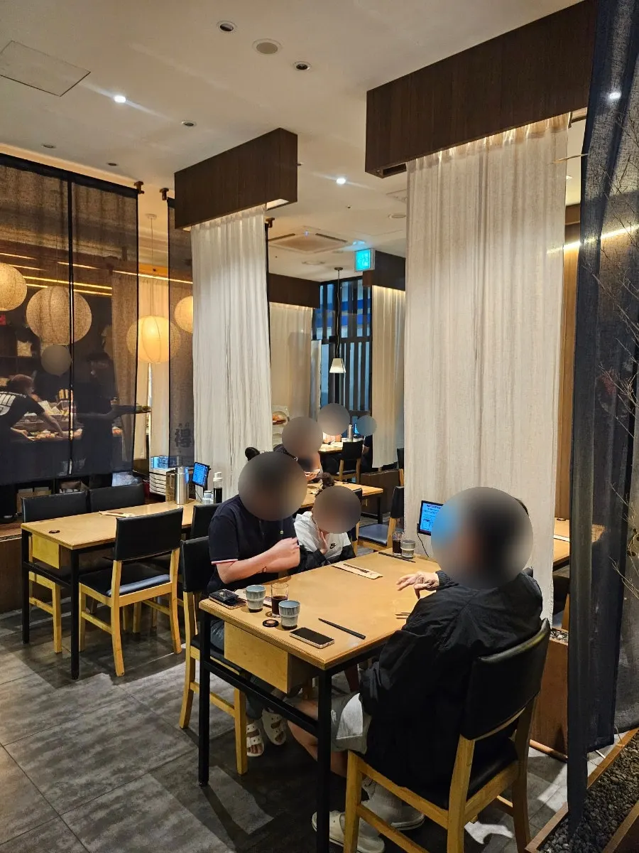 Wood-tone interior of Sushi Doku The Songdo