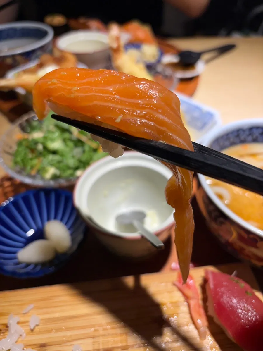 A table with a sushi set meal and side dishes