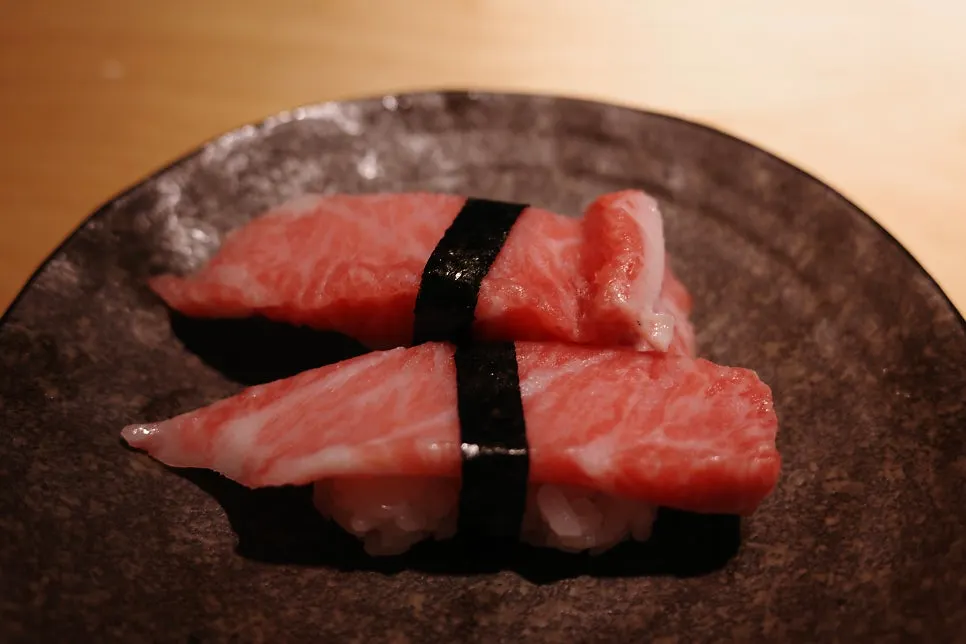 Large salmon sushi topped with wasabi