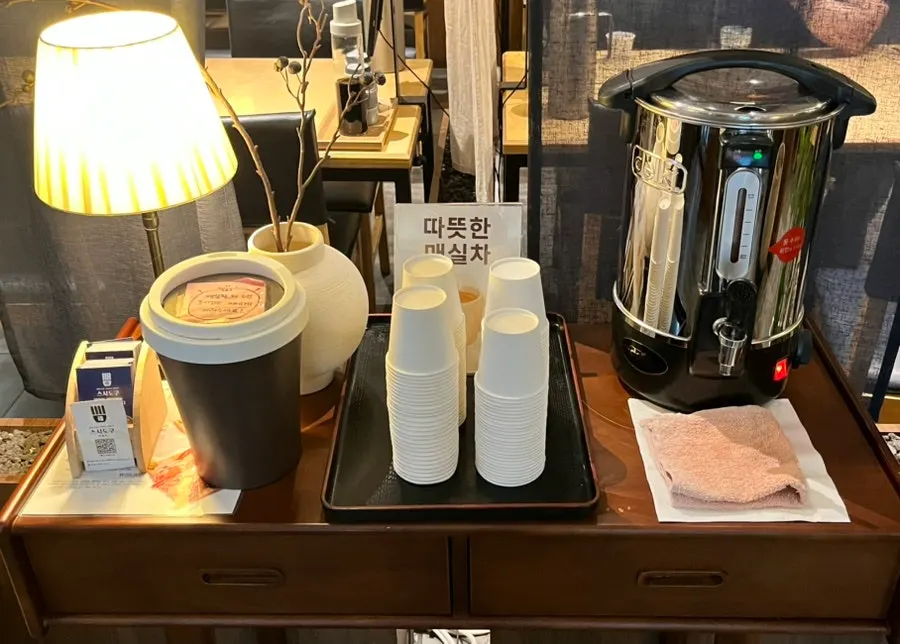 A glass of plum tea from the self-service station