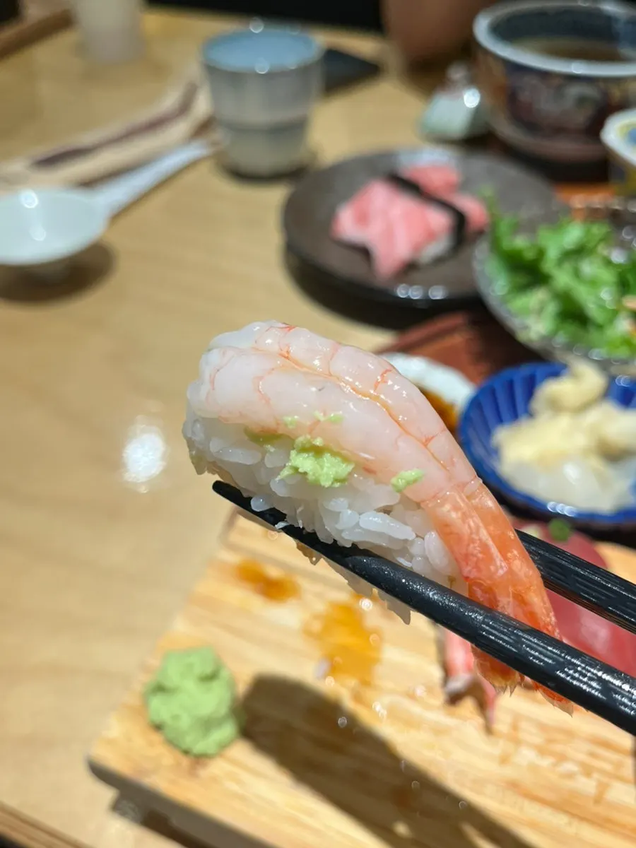A piece of red shrimp sushi