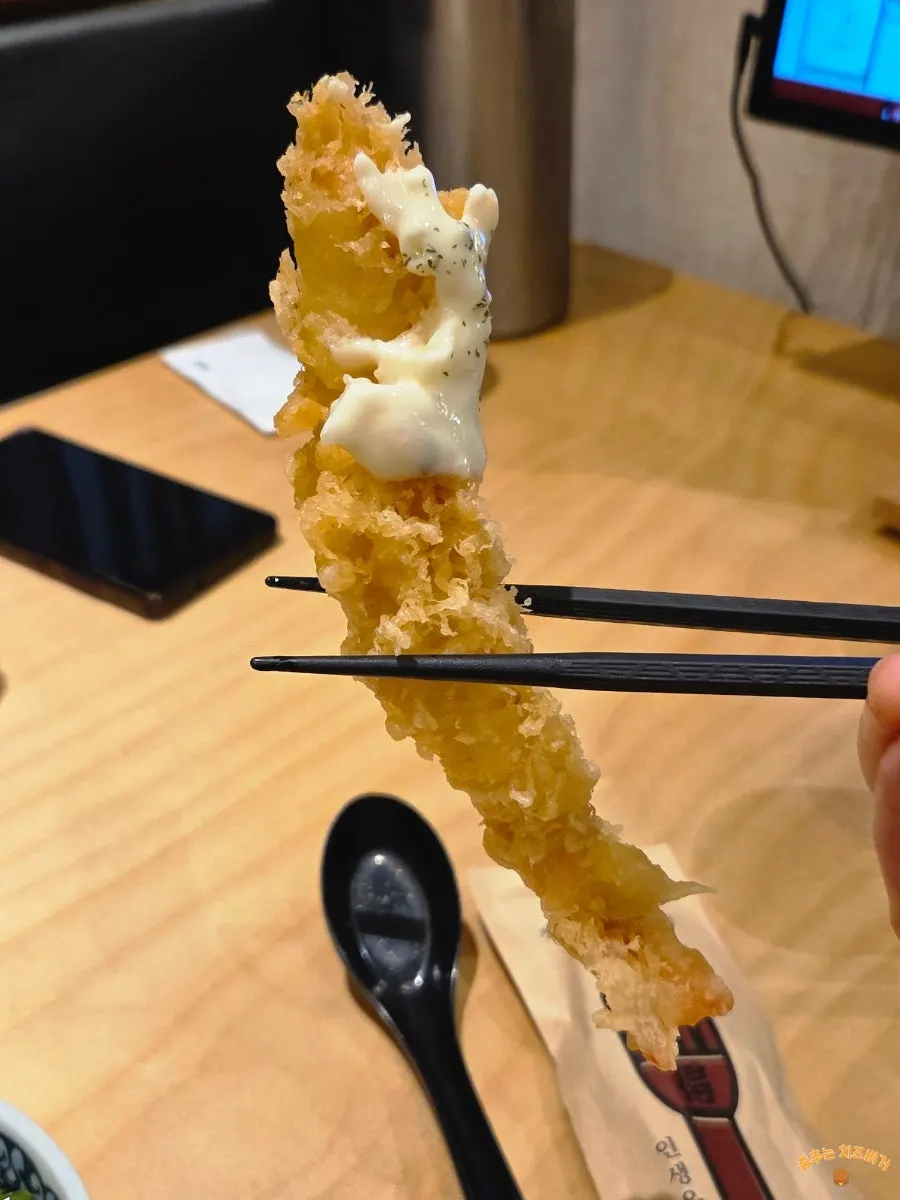 Vertical shot of shrimp tempura bigger than a palm