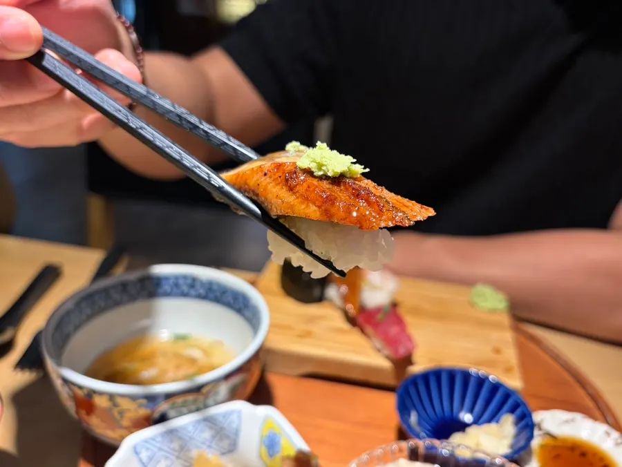 A piece of thickly cut salmon sushi