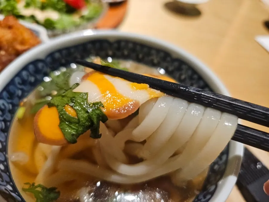 Mini udon with crown daisy greens and fish cake
