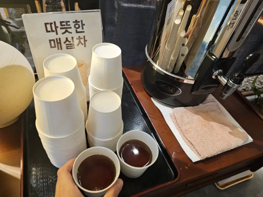 Warm plum tea served at the end of the meal
