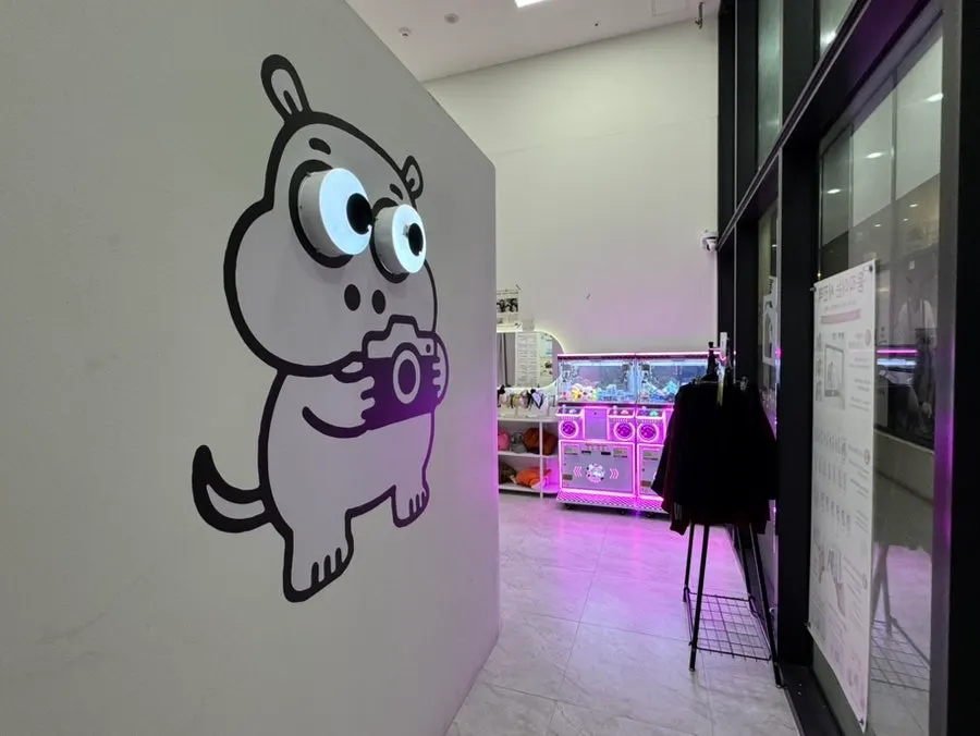 Store entrance with a hippo mascot character and Little Prince sticker frame