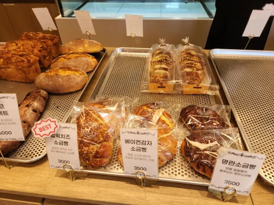 Garlic cheese, bacon potato, and myeongran salt bread on display