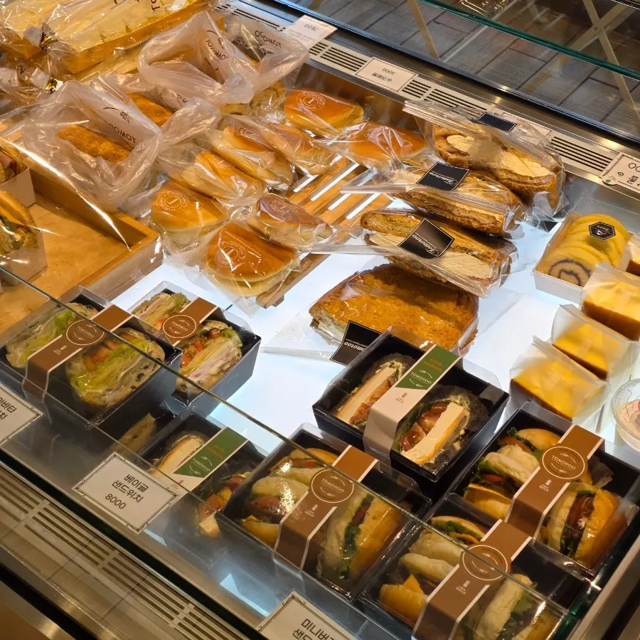 Refrigerated display of cream breads and sandwiches