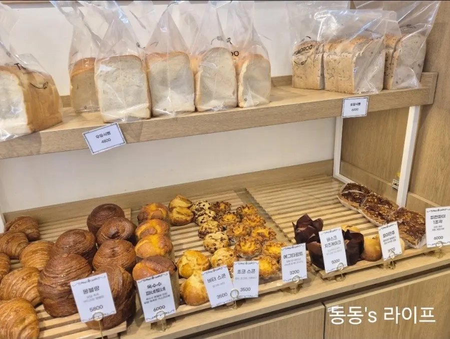 Bread display shelves inside Tomoru Bakery