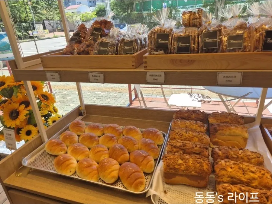 Wide view of the bread display corner at Tomoru Bakery