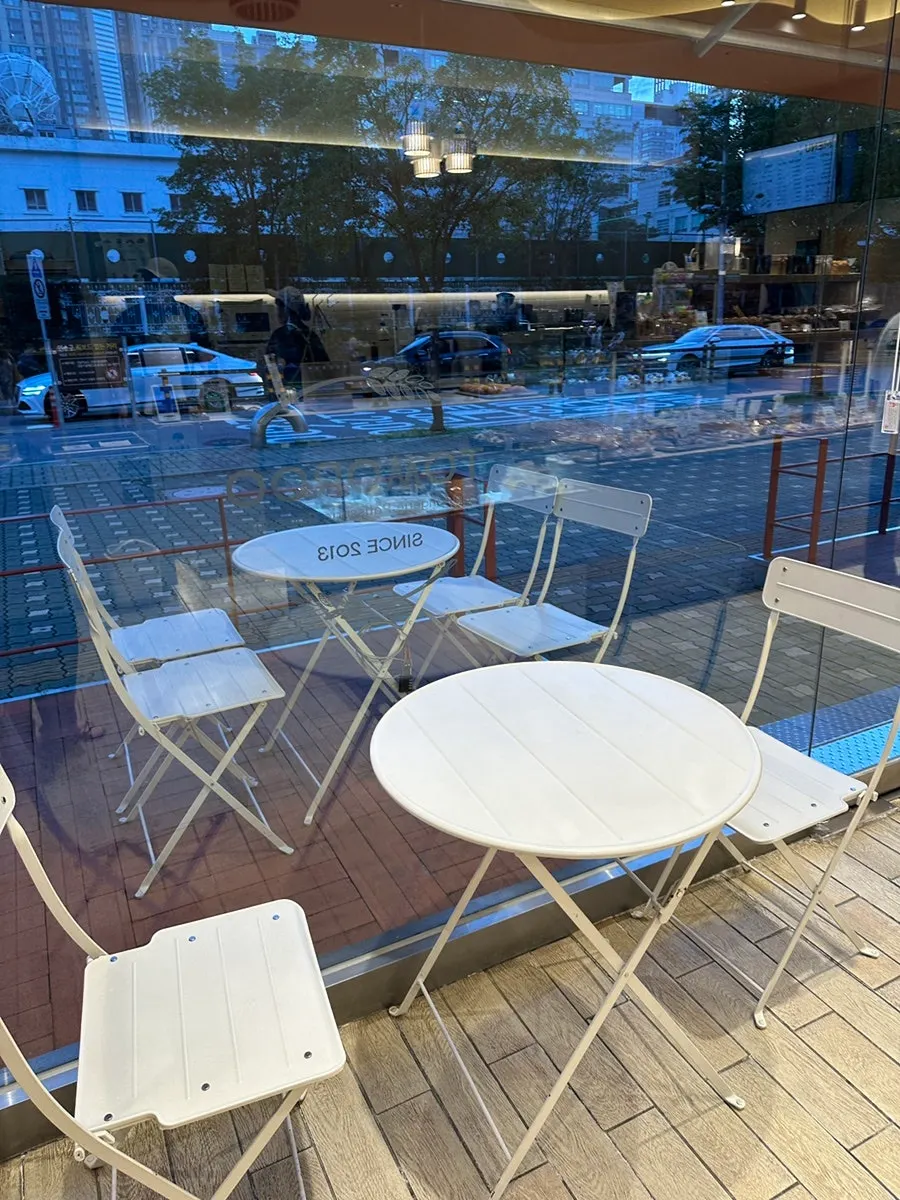 Customers coming and going at the bakery entrance on a weekday evening