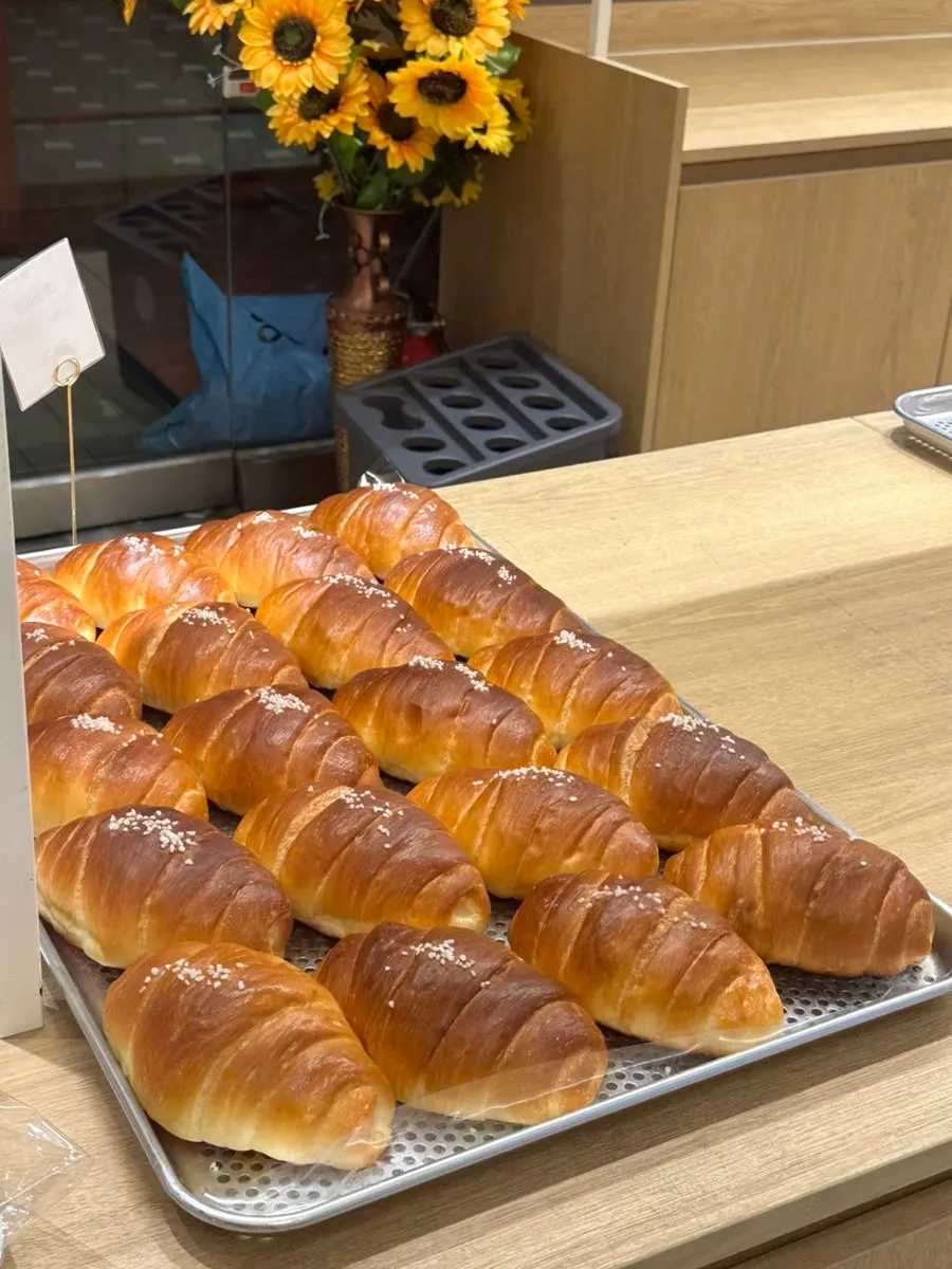 Bakery tray holding salt bread and baguettes