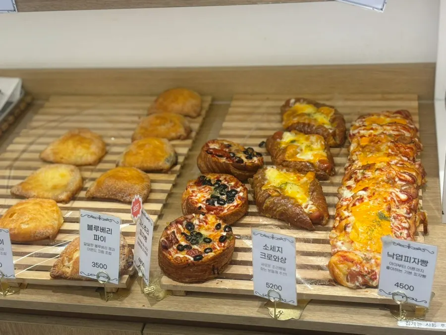 Bakery shelf stocked with a variety of breads
