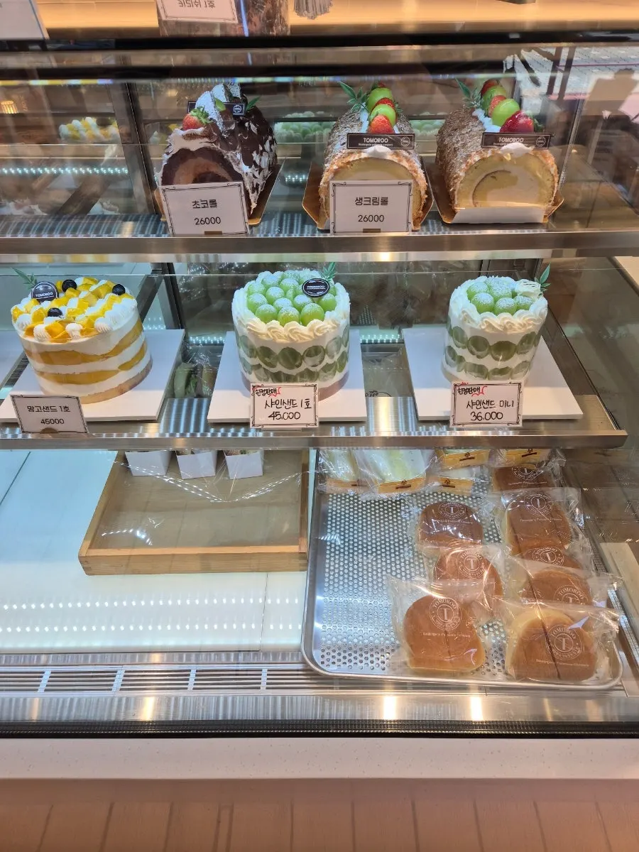 Cakes and cookies arranged in the display case