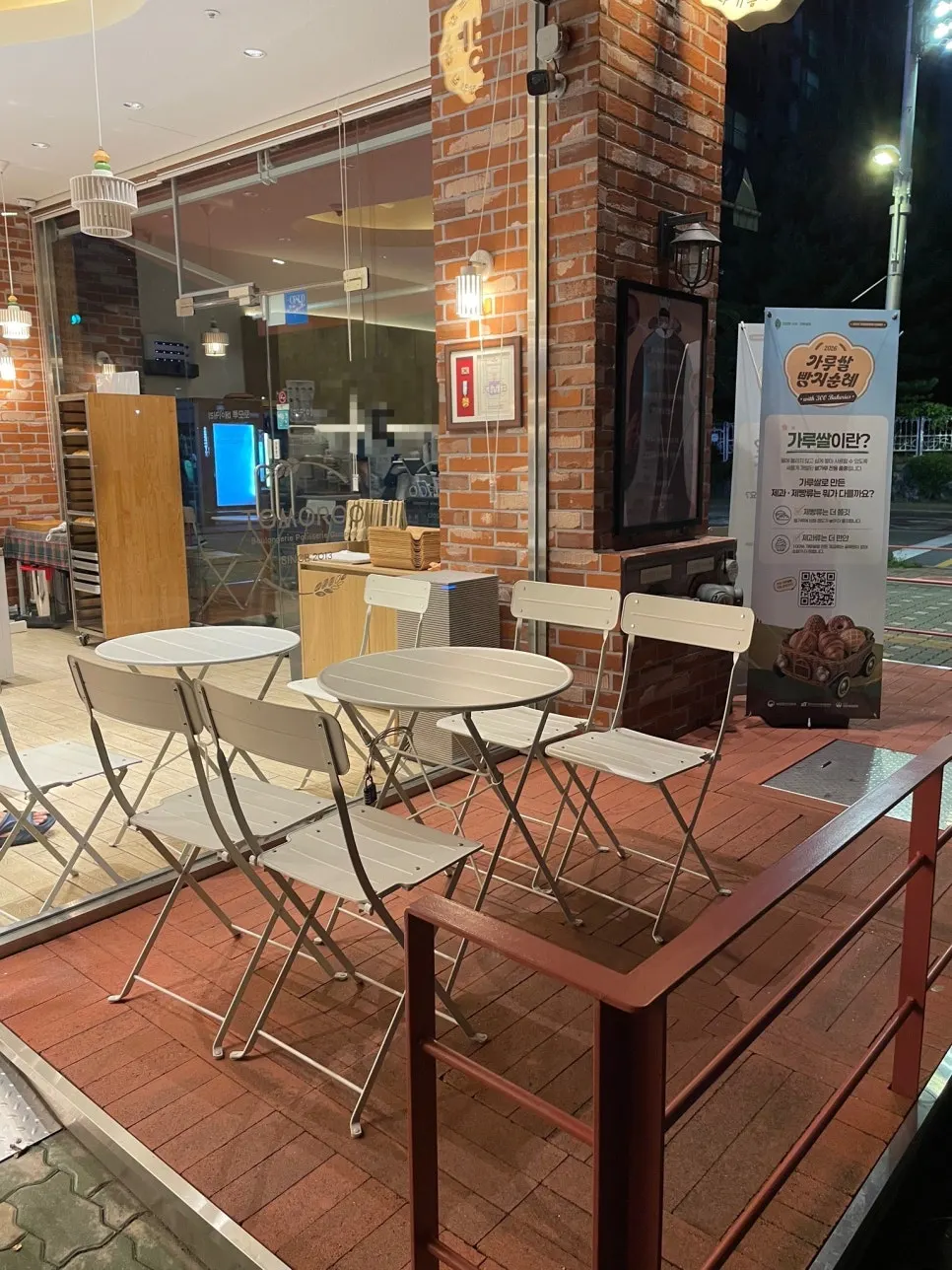 Exterior of Tomoru Bakery with brick and floor-to-ceiling glass