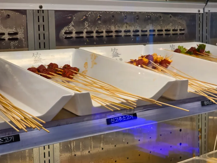 Various hot pot ingredients displayed at the self-bar