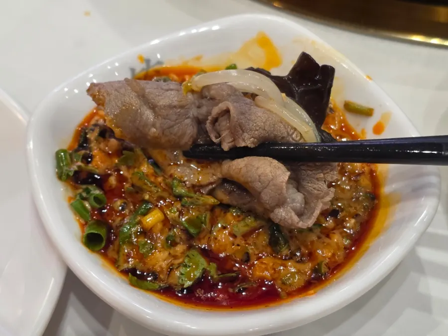 Toppings boiling in the mala red broth