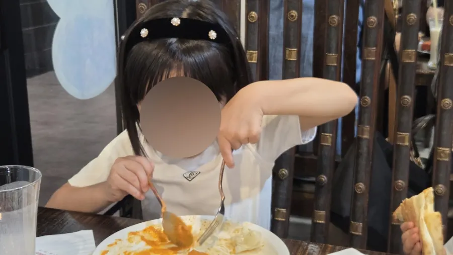 A piece of naan dipped in curry
