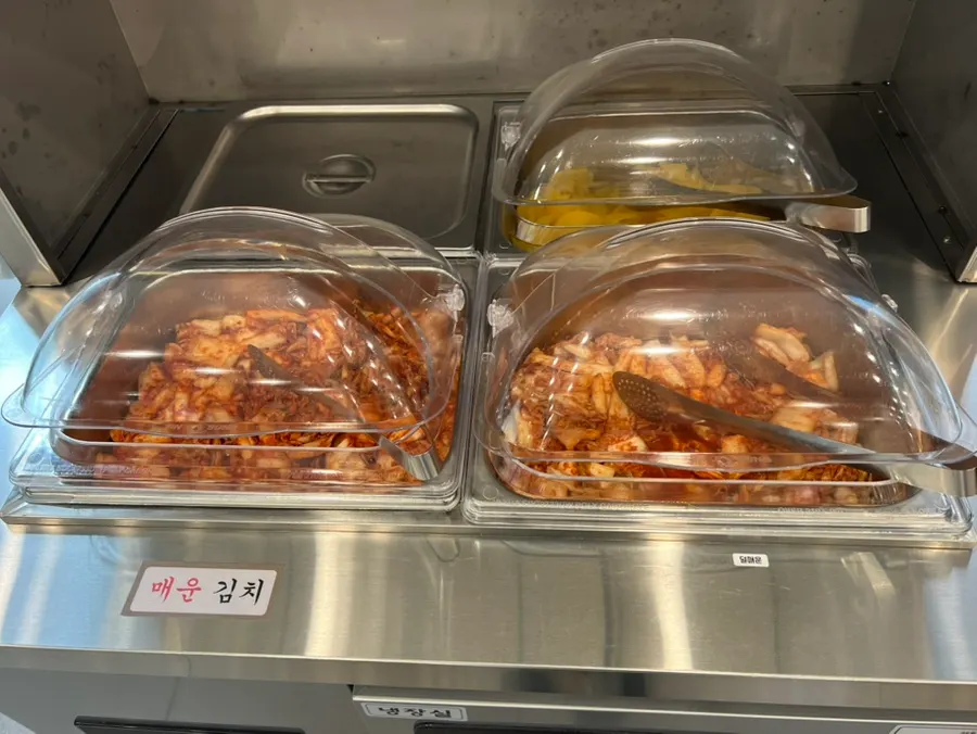 Self-serve bar with kimchi, pickled radish, and utensils
