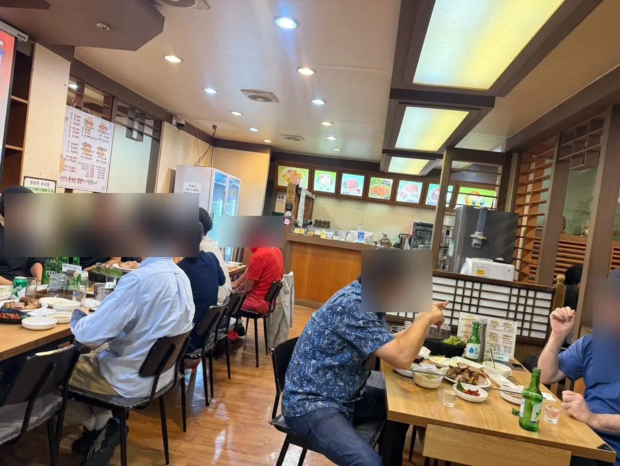 Interior of Songgane Wang Jokbal Bossam Changwon Station Branch with spaced-out tables