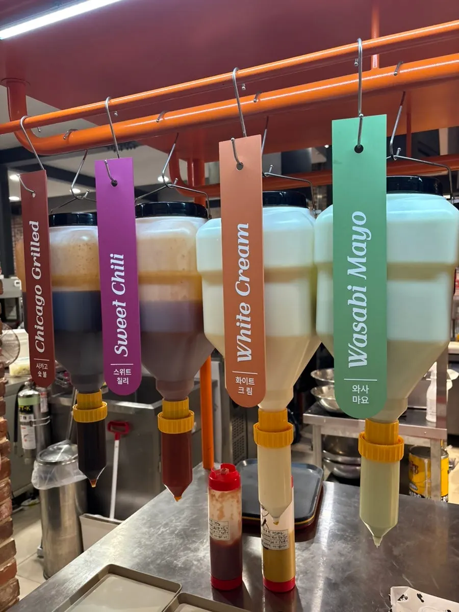 Self-serve sauce corner with 7 sauces