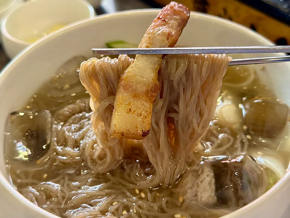 Mul naengmyeon eaten with grilled meat