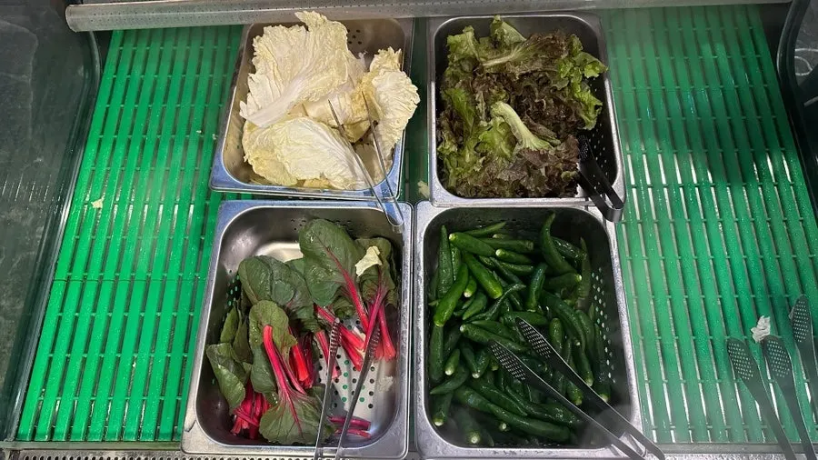 Wrap greens and side dishes available for refills at the self-service bar