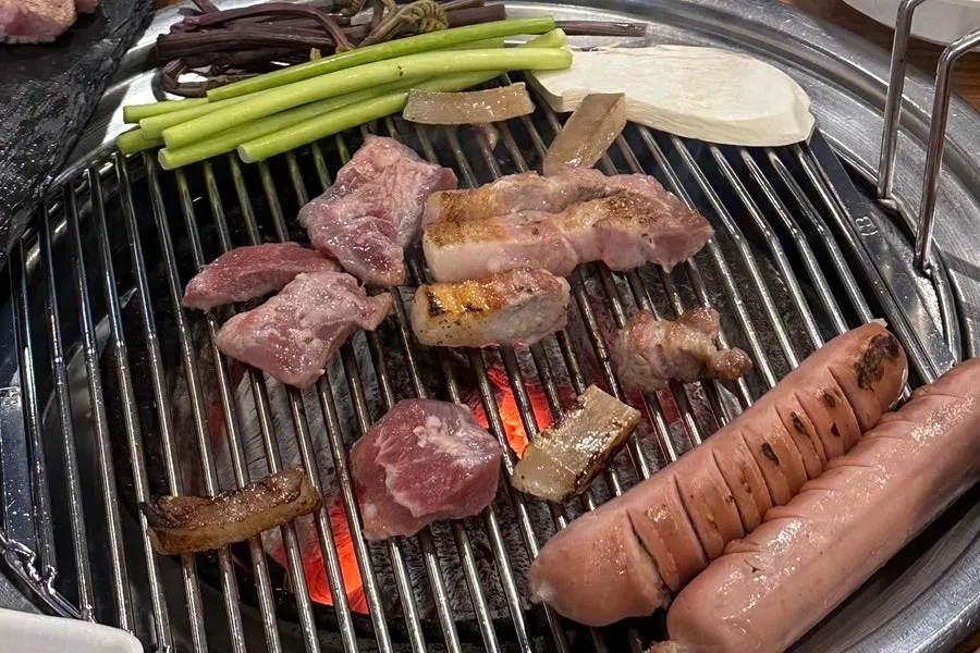 Pork skin, meat and sausage on the grill