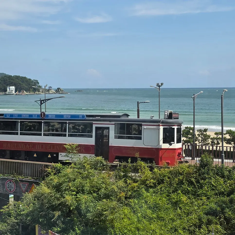 The beach train passing by through a round window