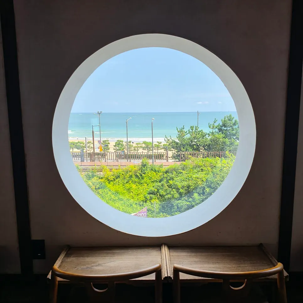 A round traditional window and the view outside