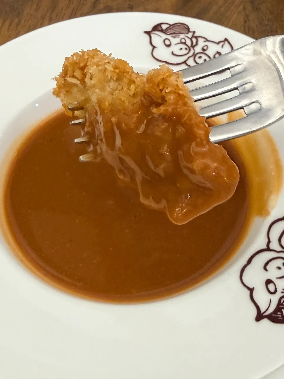 Soup and morning bread served alongside the pork cutlet