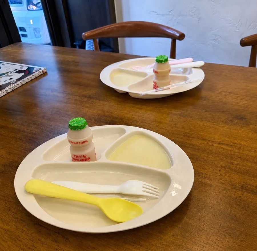 Kids' tray set up with soup and yogurt