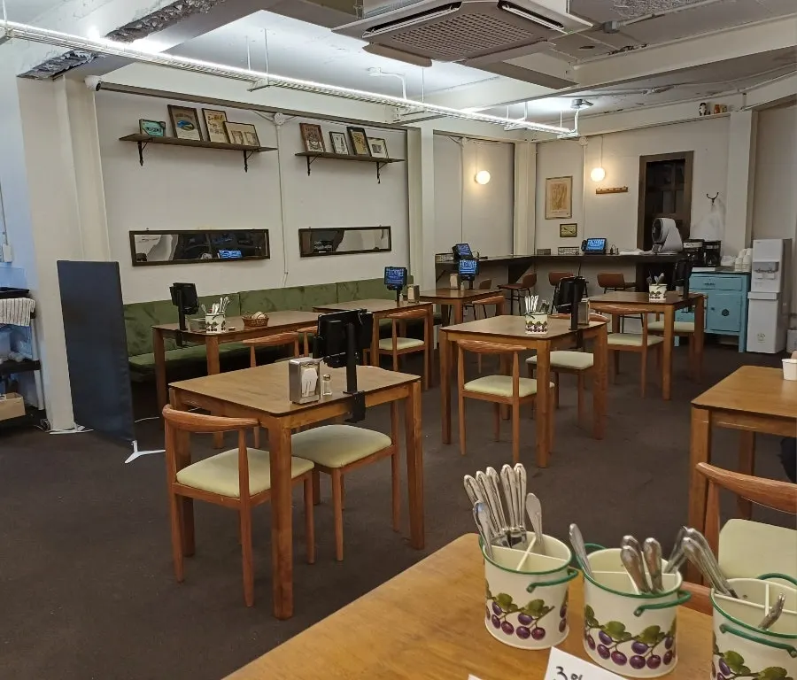 Interior dining hall of Deli Donkatsu with wooden tables