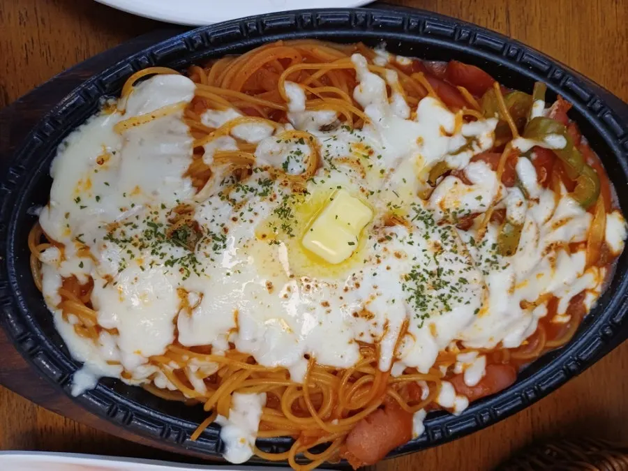 Cheese Napolitan spaghetti on a sizzling plate with butter