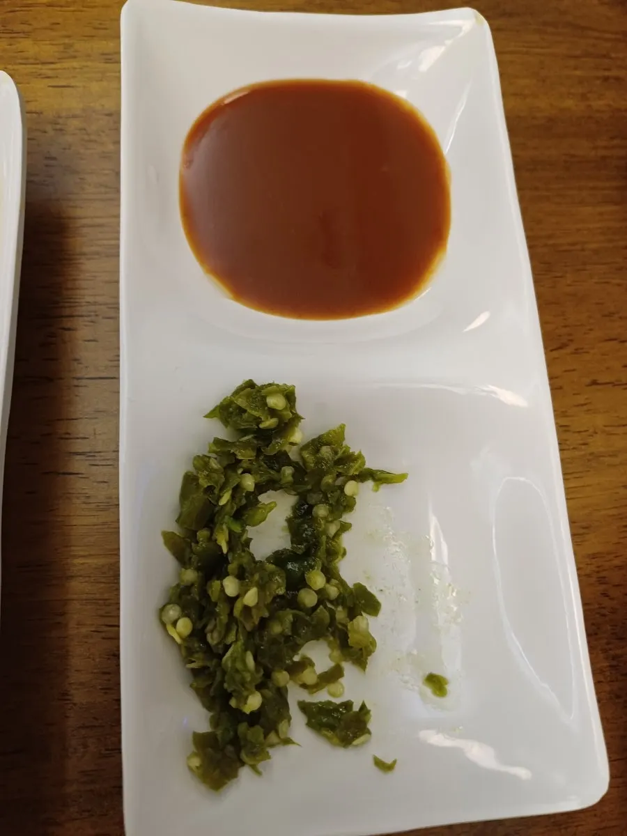 A piece of pork cutlet dipped in spicy sauce