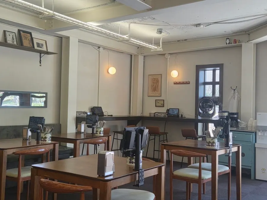Interior tables at Deli Donkatsu with generous spacing