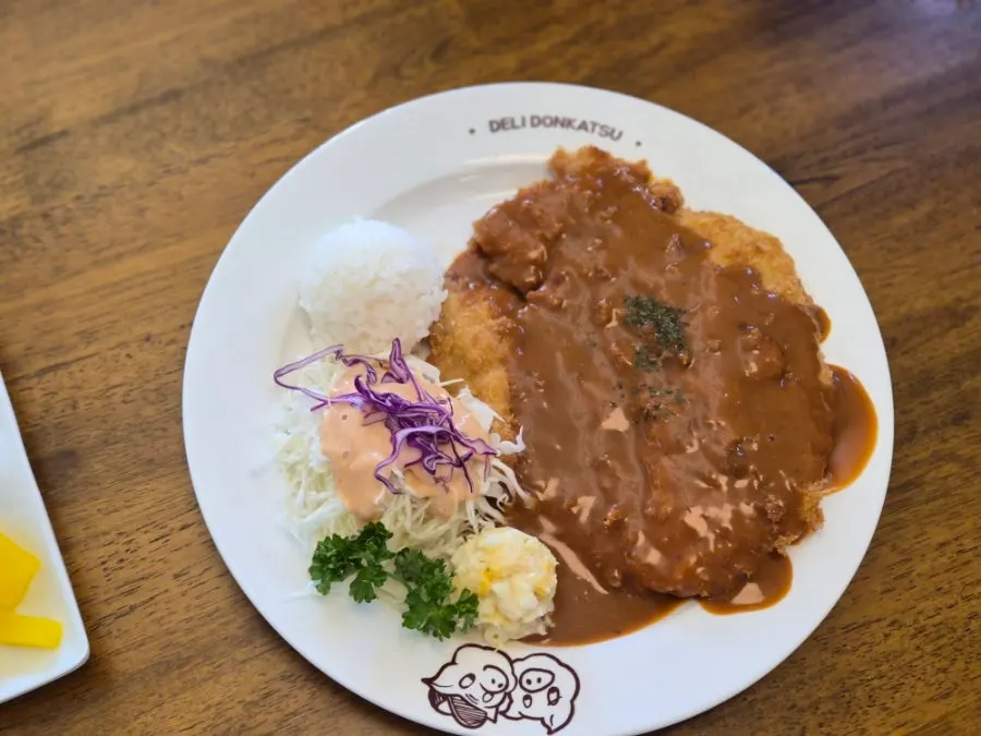 Classic pork cutlet served with rice and cabbage salad
