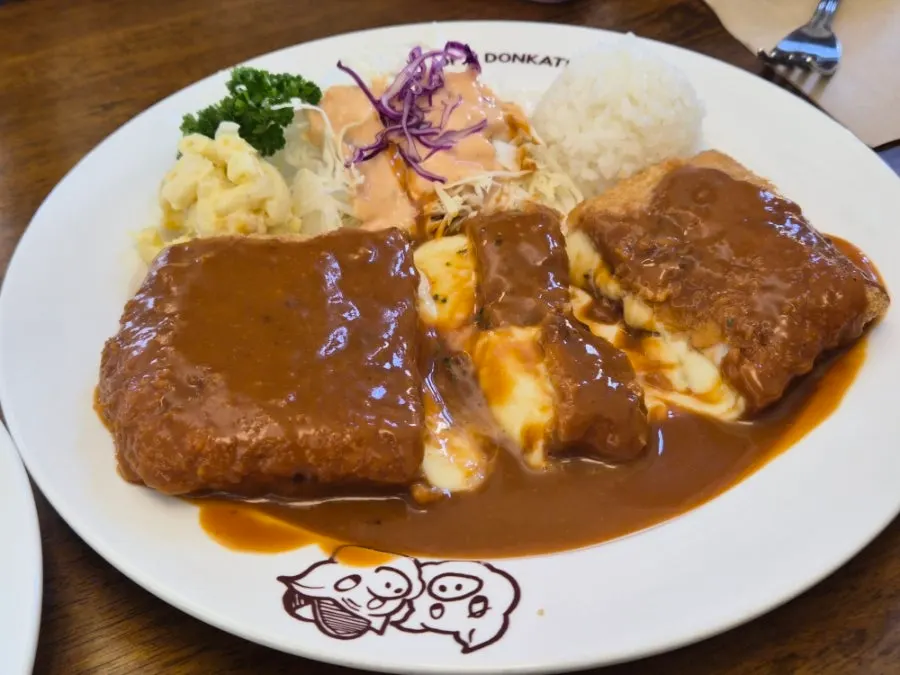 Cheese pork cutlet cut open with stretchy cheese