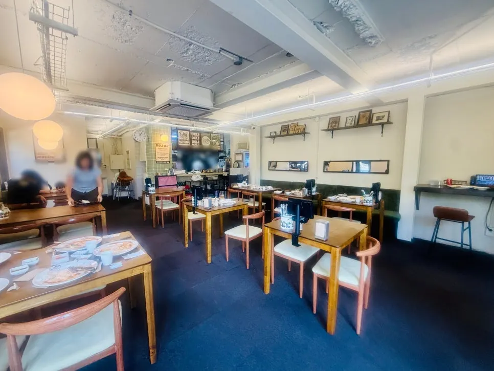 Interior dining hall at Deli Donkatsu with warm wood-toned lighting