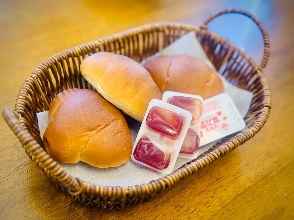 Morning rolls served with a packet of strawberry jam