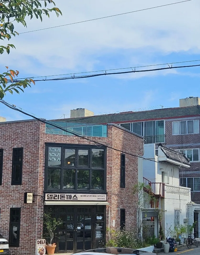 Red brick exterior of Deli Donkatsu